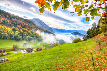 Astonishing autumn view on suburb of Hergiswil village with mountaines and fog.