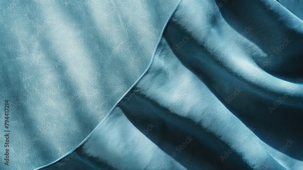Poster close-up of smooth blue fabric with light and shadow creating wavy pattern