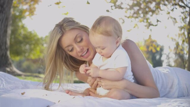 Beautiful Blonde mom and cute baby boy family fun outdoor
