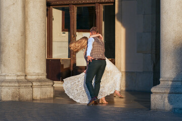An elegant couple dances outdoors, embodying timeless romance against a backdrop of historical...