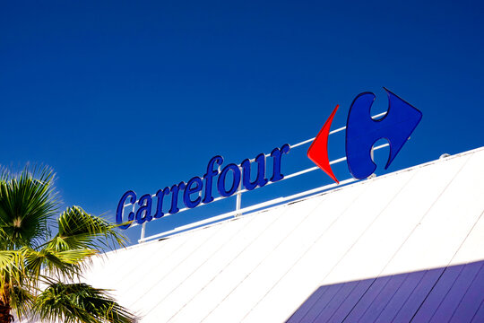 Finestrat, Spain - April 24, 2024: Carrefour logo sign on Carrefour supermarket. Carrefour is French multinational retail and wholesaling corporation