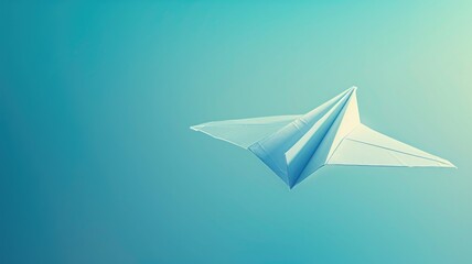 Fototapeta na wymiar White paper airplane against blue background mid-flight