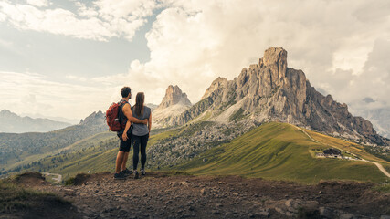 Couple of backpackers embraced contemplating the majestic mountains in front of them. immensity....
