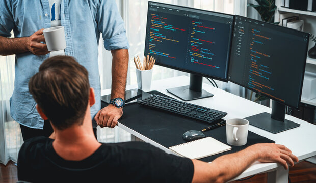 IT developers discussing online software development information on pc screen, creating program coding for latest version application on website. Concept of brainstorming firmware updated. Sellable.