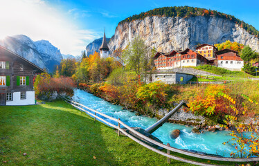 Stunning autumn view of Lauterbrunnen village with awesome waterfall  Staubbach  and Swiss Alps in...