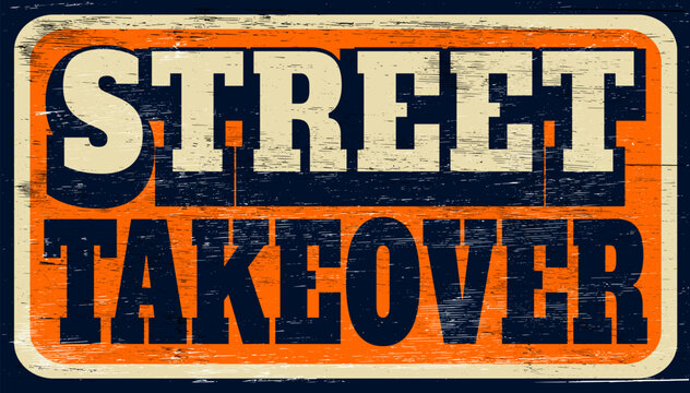 Aged and worn street takeover sign on wood