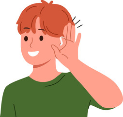 Boy uses hearing aid and puts palm to ear, rejoicing at availability of technological solutions to health problems. Schoolboy with hearing aid smiles listening to sounds around him.