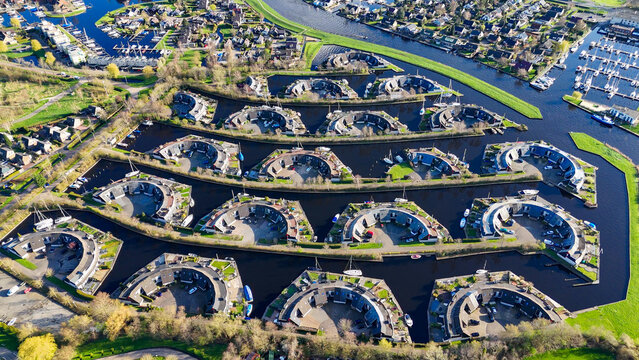 Aerial drone view geometric pattern of water houses, marina, yachts Marina Park Lemmer Netherlands
