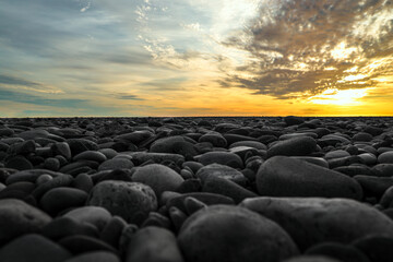 horizon line. pebble beach of the lake. Beautiful sunset in the background.,   stony beach of Black...