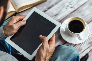 Person Holding Tablet with Blank Screen While Having Coffee, E-book and Glasses in Background on Table