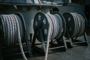 A ship's mooring rope tied to a dock, securing the vessel in place, ensuring stability and preventing it from drifting away