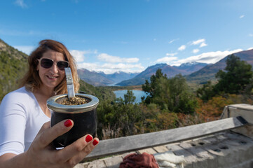 Woman enjoying a delicious Argentine mate during her summer vacation in Patagonia, Argentina.