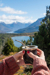 Argentine Mate held in the hands of a beautiful lady surrounded by beautiful landscapes of southern...
