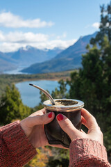Argentine Mate held in the hands of a beautiful lady surrounded by beautiful landscapes of southern Argentina.