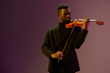 Young black man playing violin against vibrant purple background in 3D render, showcasing musical...