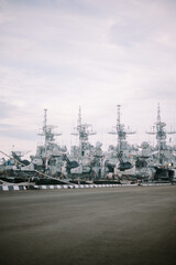 Photo of a naval warship docked at the pier, showcasing military power and readiness, against the...