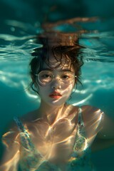 A woman in a swim suit under water