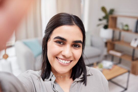 Portrait, smile and selfie of girl in home living room for social media, memory and beauty of skin in Dubai. Face, photography and profile picture of woman, person or influencer with hair in lounge