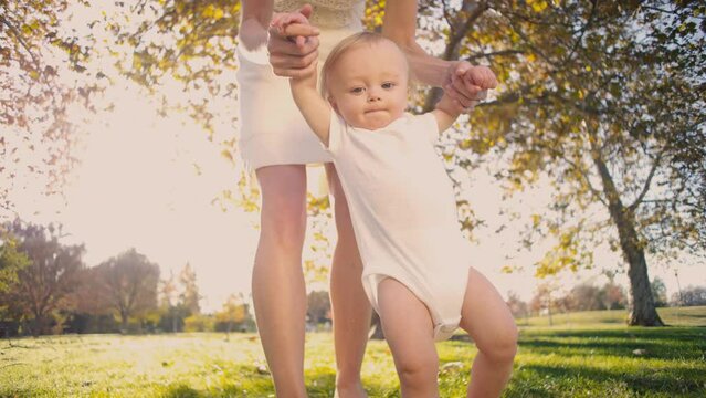 Beautiful Baby Boy First life steps with mother Outdoor 