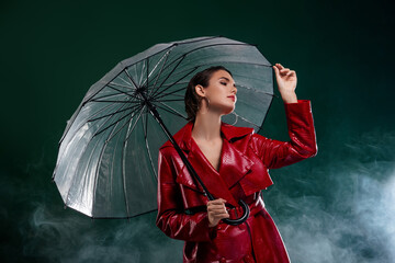 Photo of attractive girl hold umbrella wear coat look profile side isolated dark misty background