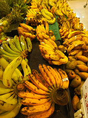 Bananas displayed in a fruit shop showcase, exhibiting their bright yellow color and appealing...