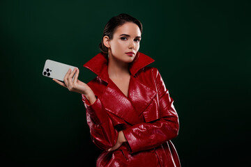 Naklejka premium Photo of attractive girl hold cell smart device look elegant wear coat isolated dark color background