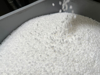  filling a deposit with white plastic pellets, production of plastic parts, plastic injection,...