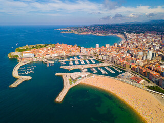 Aerial cityscape of Spanish city Gijon with sand beach and quarters