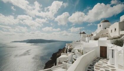 white architecture in santorini island greece view of the sea and the blue sky with clouds - obrazy, fototapety, plakaty