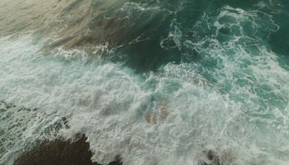 from above aerial view of turquoise ocean water with splashes and foam for abstract natural background and texture