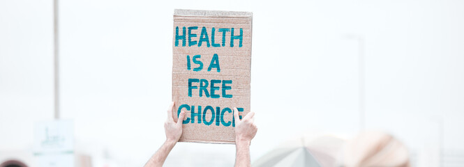 Person, hands and protest with billboard or sign for health, freedom or choice of anti vaccine on...