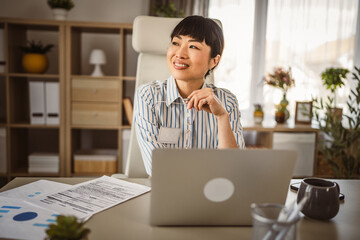 Mature japanese woman sit and think at office positive