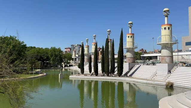 BARCELONA, SPAIN - April 14, 2024: This is a modern Industrial Spain Park, created on the site of the former industrial zone of the city. Ponds, weeping willows and lighthouses. A place to relax.