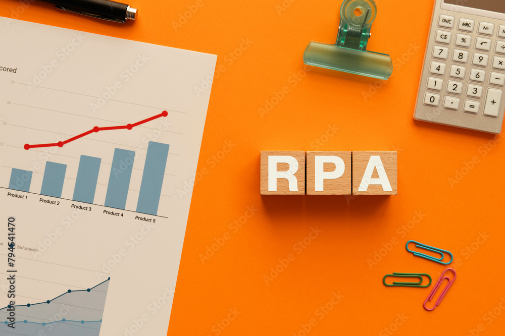 Poster there is wood cube with the word rpa. it is an abbreviation for robotic process automation as eye-ca