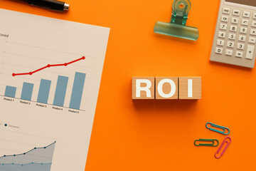 There is wood cube with the word ROI. It is an abbreviation for Return On Investment as eye-catching image.