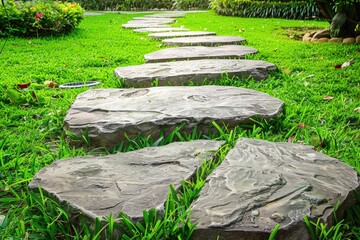 Stone walkways in the garden, with green grass surrounding 