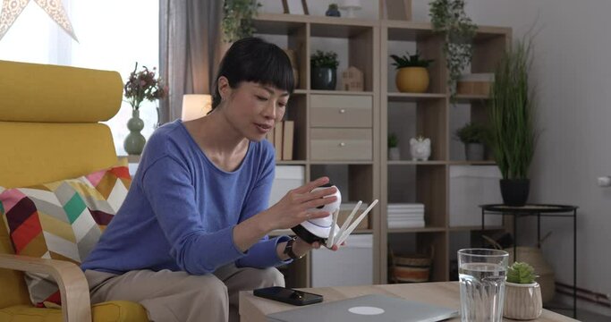 mature japanese woman adjust prepare home surveillance security camera