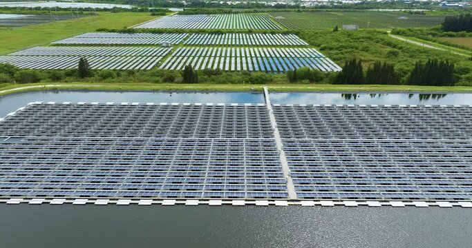 Production of sustainable photovoltaic electricity on water surface with zero emission. Floating solar panels at renewable electrical power plant for producing clean electric energy