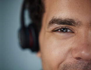 Closeup of businessman and face at call centre with headphones for communication, contact and...