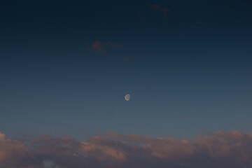 Waxing moon against the daytime sky