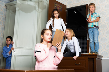 Smart tween girl trying to solve conundrum to get out of escape room with her friends