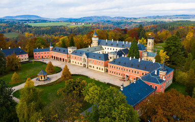 View from drone of impressive medieval Sychrov Castle with large park on sunny autumn day, Liberec...