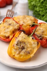 Delicious stuffed peppers on white table, closeup
