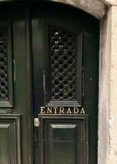 the allure of Portugal with this vintage emerald green door, a symbol of the country's rich...