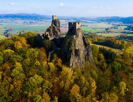 Aerial view of ancient ruined Trosky Castle high on summits of two basalt volcanic plugs on background of autumn landscape of Bohemian Paradise, Czech Republic..