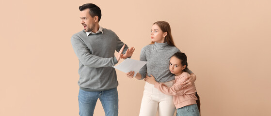 Sad little girl with her parents getting divorce on beige background