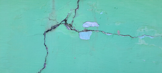 Concrete cement green wall with crack in industrial building