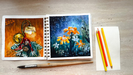 Sketchbook with vivid colorful watercolor illustrations and art tools on table. Aquarelle sketching. Watercolour sketches on paper. Film grain texture. Soft focus. Blur