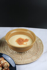 Steamed egg with garlic on white table. Thai street food restaurant menu. Home cooking concept.