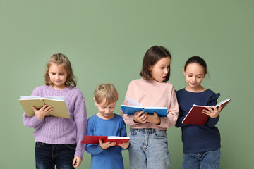 Little children reading books on green background